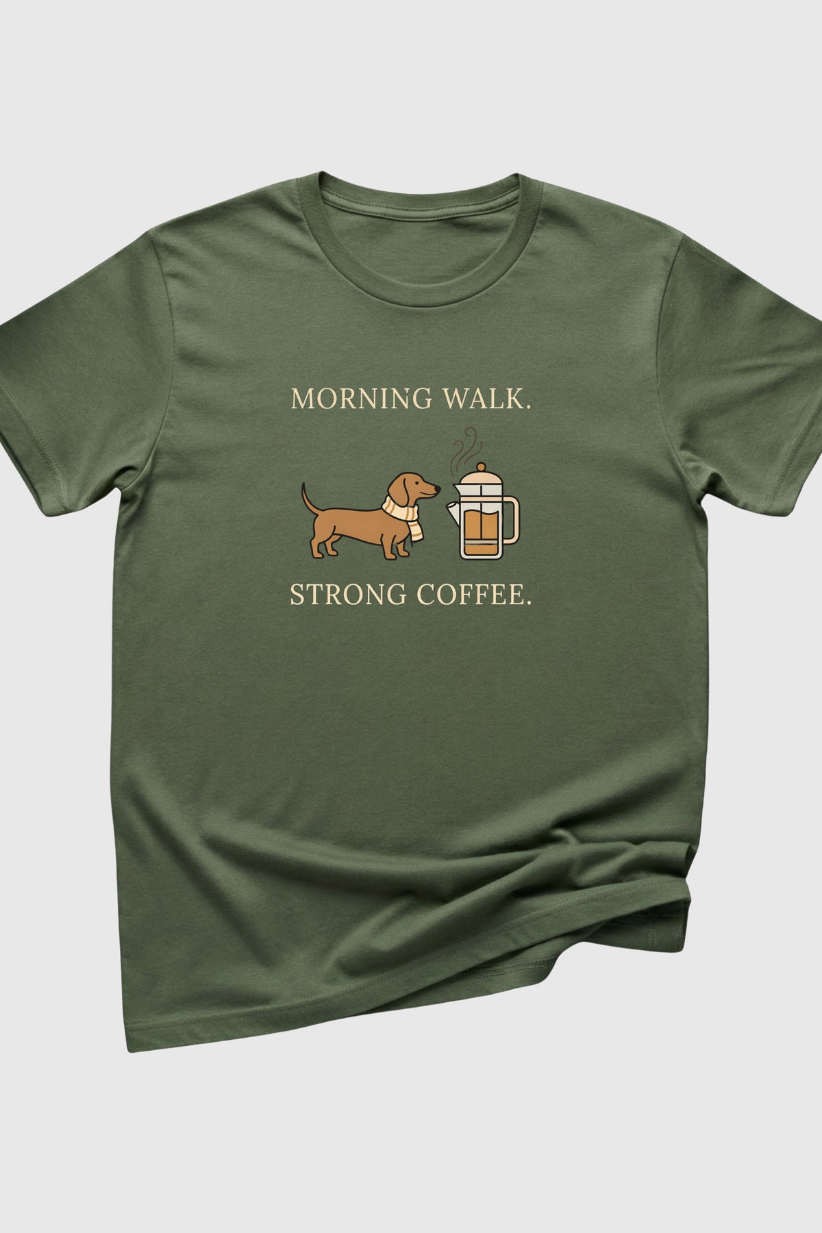 Green t-shirt with a dachshund and coffee cup graphic and text on a white background