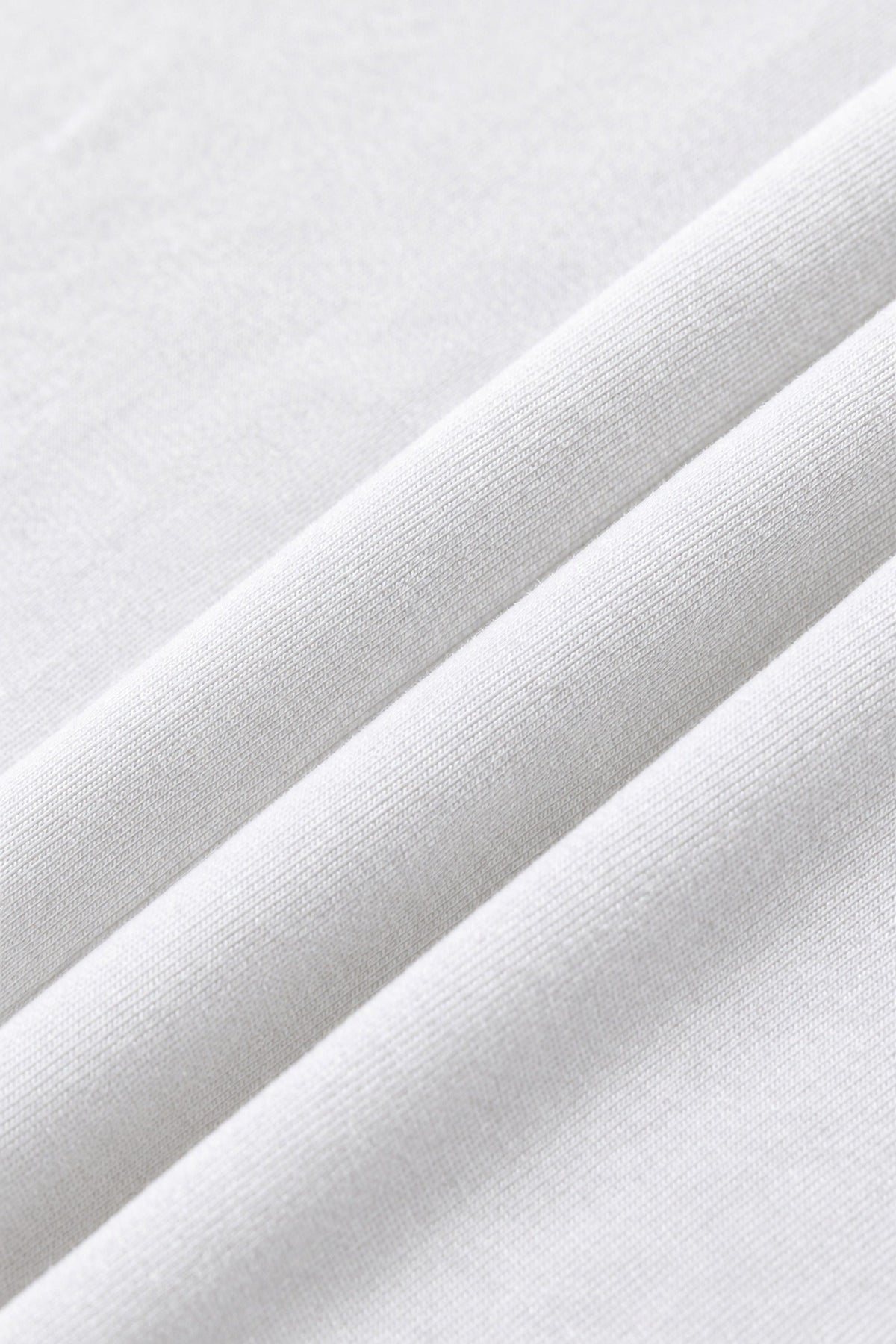 White 260 gsm heavyweight cotton fabric, close-up. Color: White