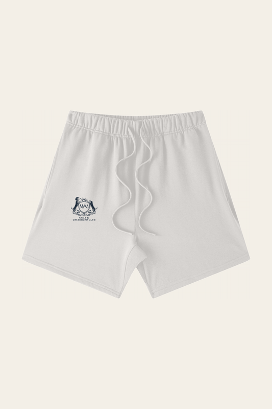 Flat lay of oat gray Club Crest shorts with the small navy Golf & Dachshund Club crest on the leg, front view. Color: Oat Gray