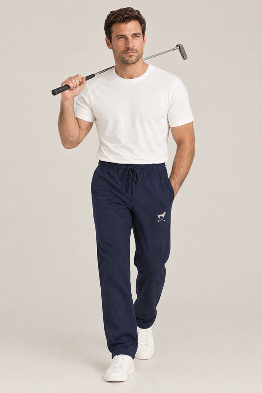 Man walking with a putter on his shoulder in navy blue Club Mark dachshund golf sweatpants and a white tee. Color: Navy Blue