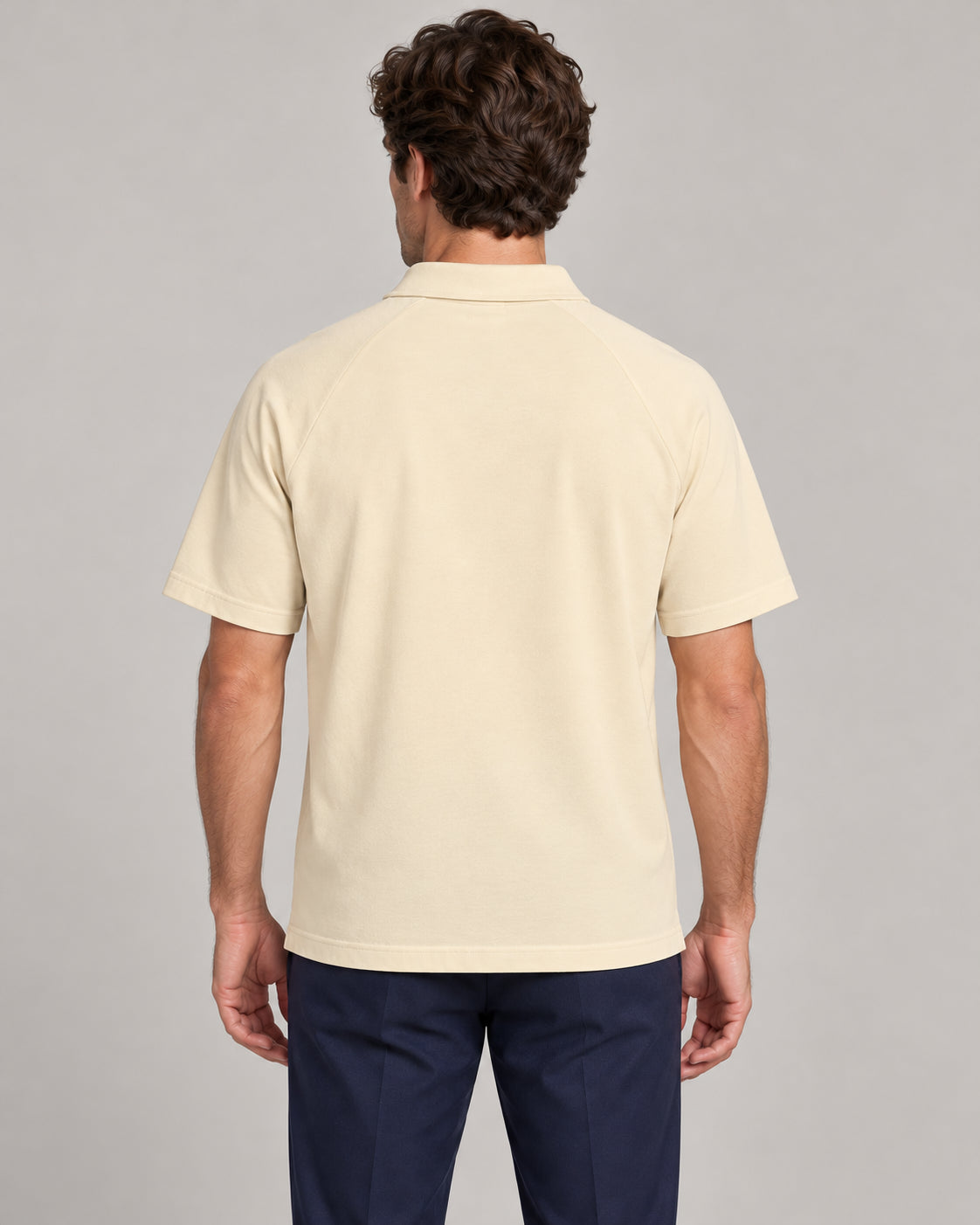 Man wearing Putting dachshund golf polo, back studio view. Color: Apricot