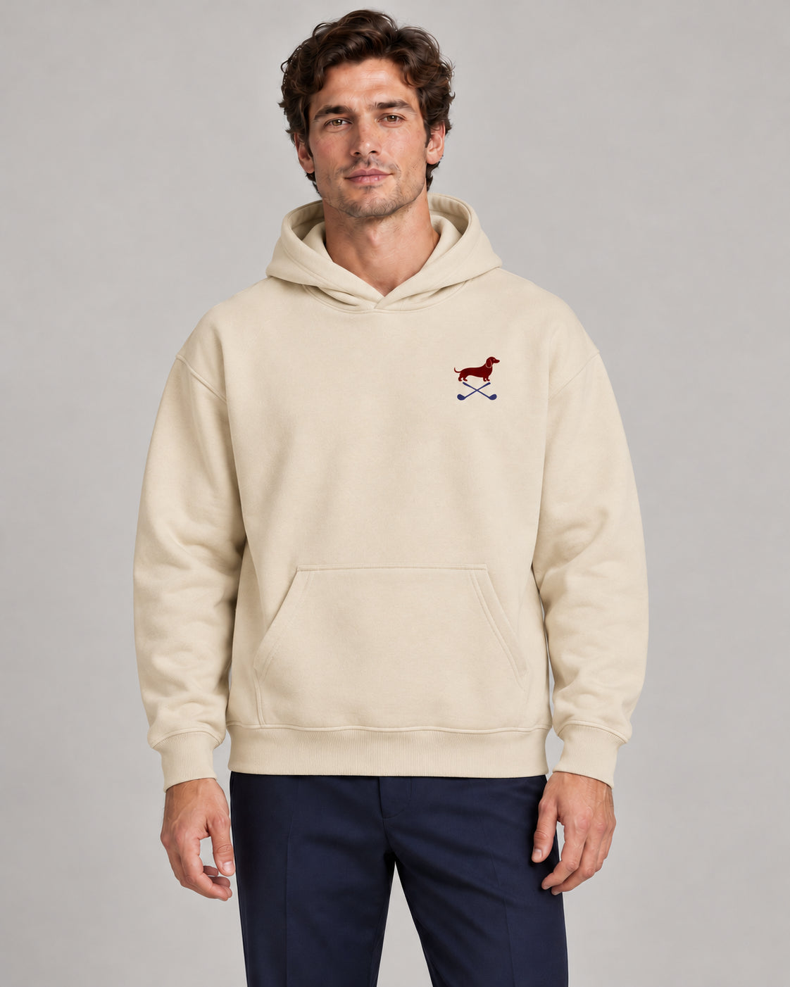Man wearing Club & Swing dachshund golf hoodie, front studio view. Color: Apricot
