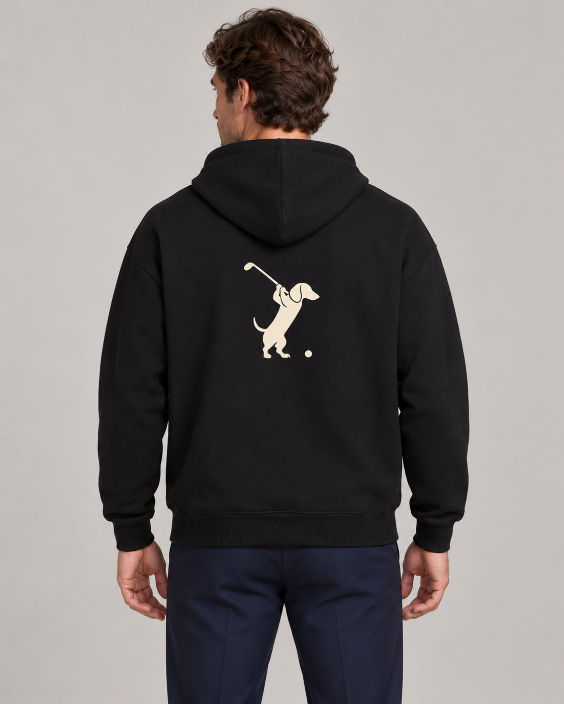 Man wearing Club & Swing dachshund golf hoodie, back studio view. Color: Black