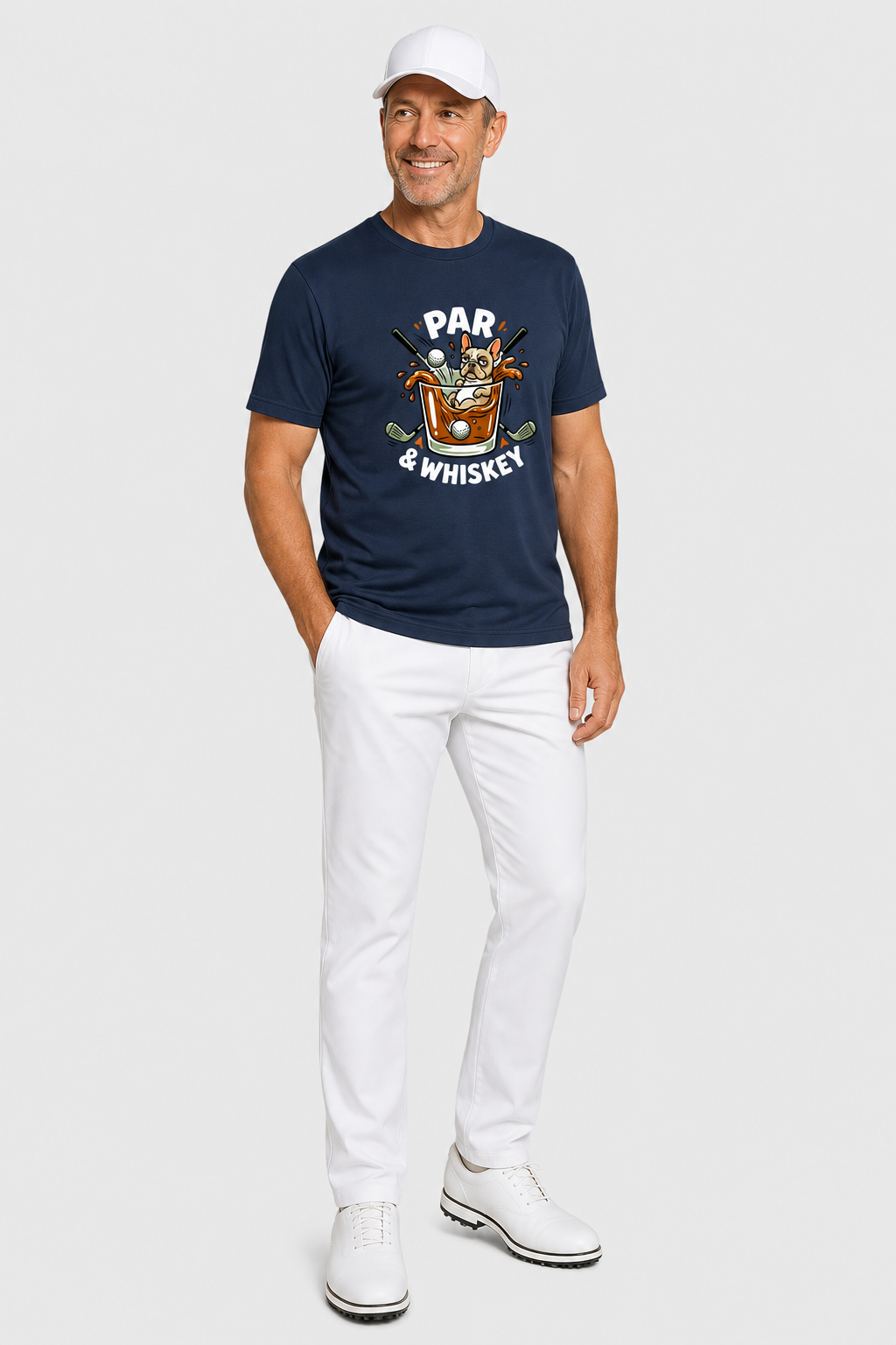 Man wearing a navy t-shirt with a graphic design and white pants on a white background