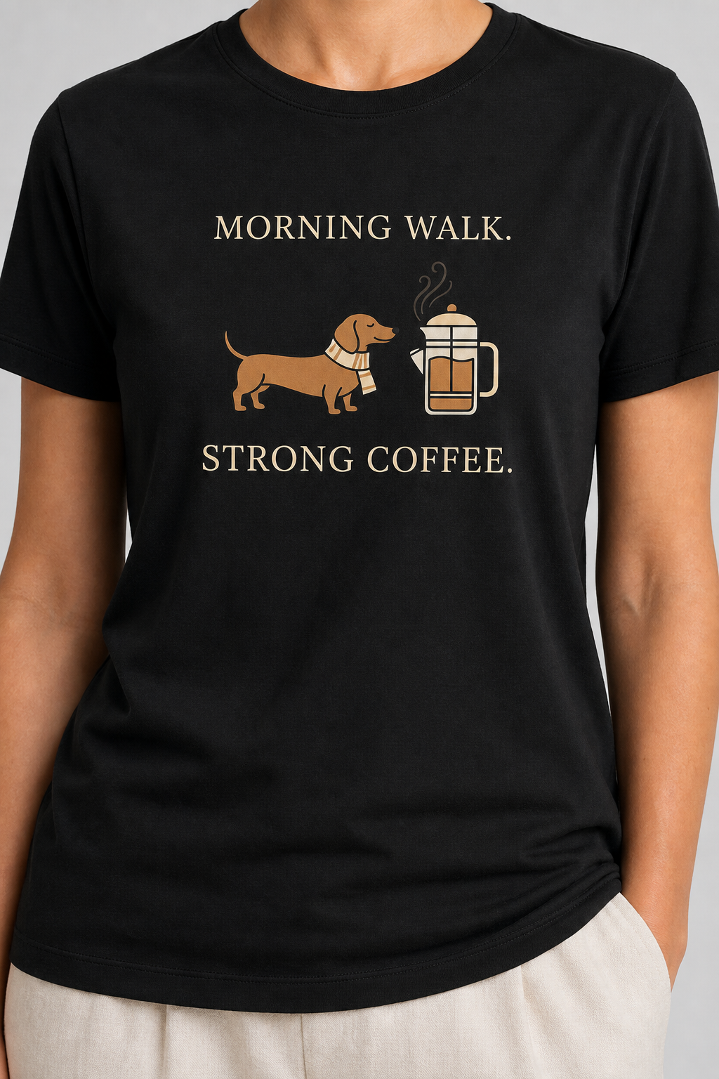 Black t-shirt with a dachshund and coffee graphic and text 'Morning Walk, Strong Coffee' on a plain background.