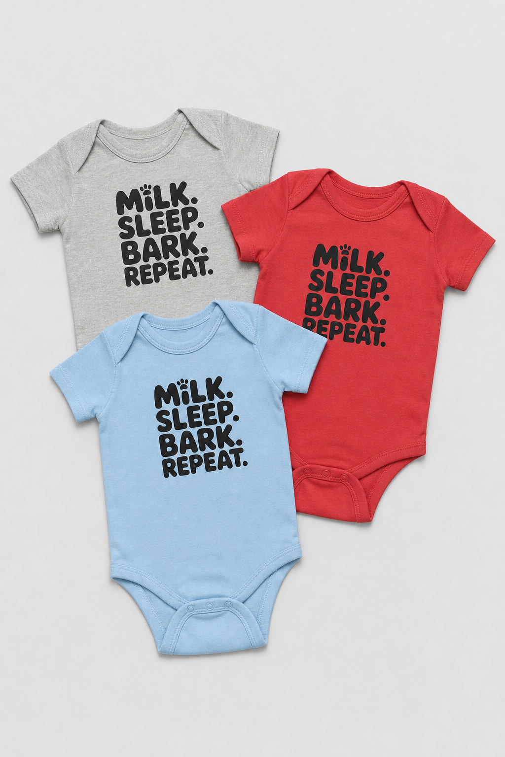 Baby wearing pink Milk Sleep Bark Repeat bodysuit