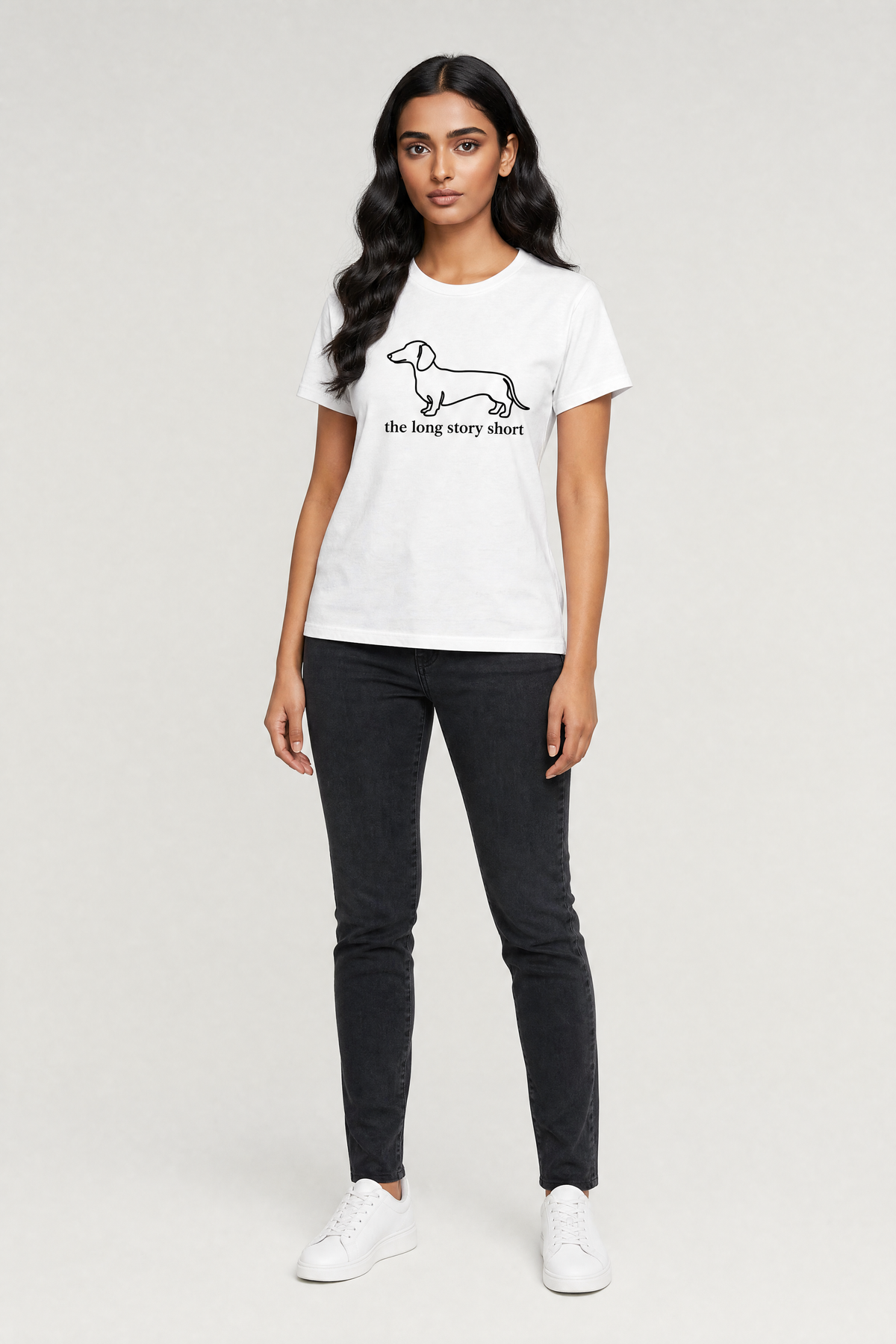 Woman wearing a white t-shirt with a graphic design on a plain background