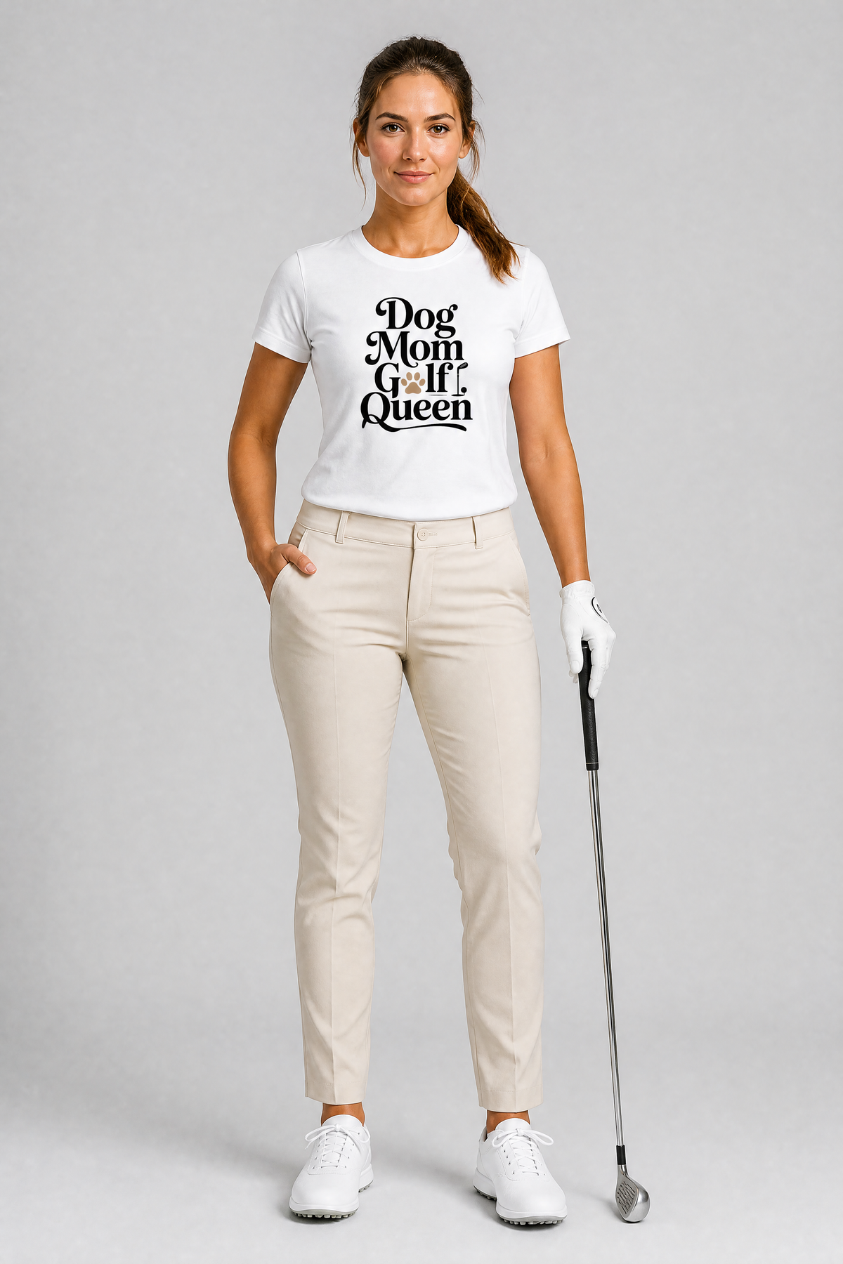 Woman in golf attire with a 'Dog Mom Golf Queen' t-shirt on a gray background