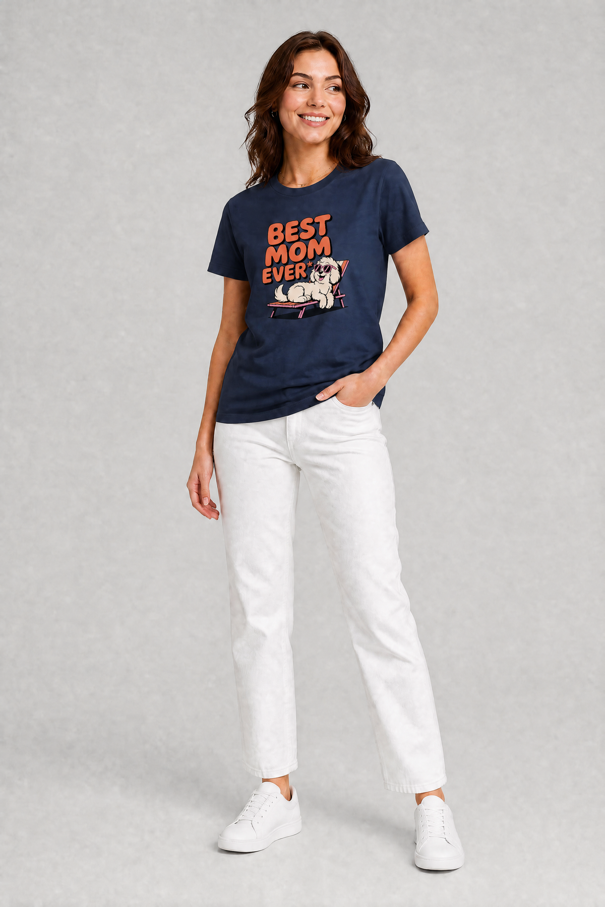 Woman wearing a navy t-shirt with 'Best Mom Ever' text and a dog graphic, paired with white pants on a gray background.