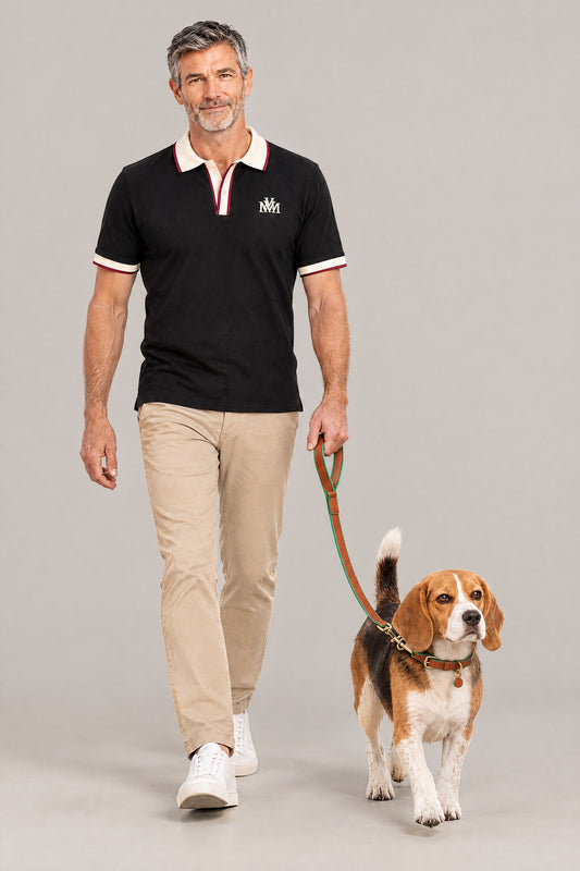 Man in the black Club Crest color block polo walking a beagle on the cognac green Cloud 7 Kings Park leash
