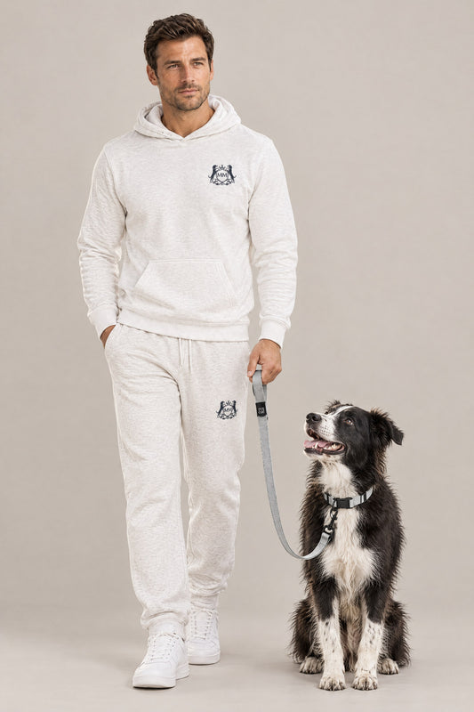 Man in the white Club Crest hoodie with a border collie mix on the silver Cloud 7 RESC7UE leash and collar