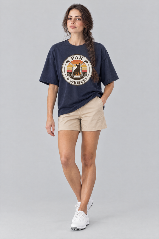 Woman wearing the Par & Whiskey French Bulldog Badge Golf Tee in navy with beige chino shorts. Color: Navy