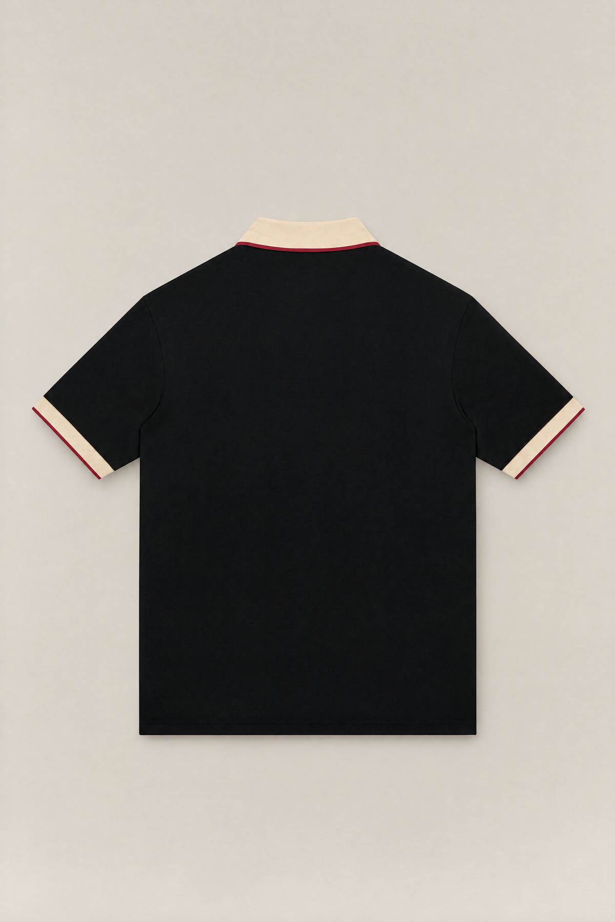 Club Crest color block polo in black with apricot collar and cuffs, back view packshot. Color: Black with Apricot