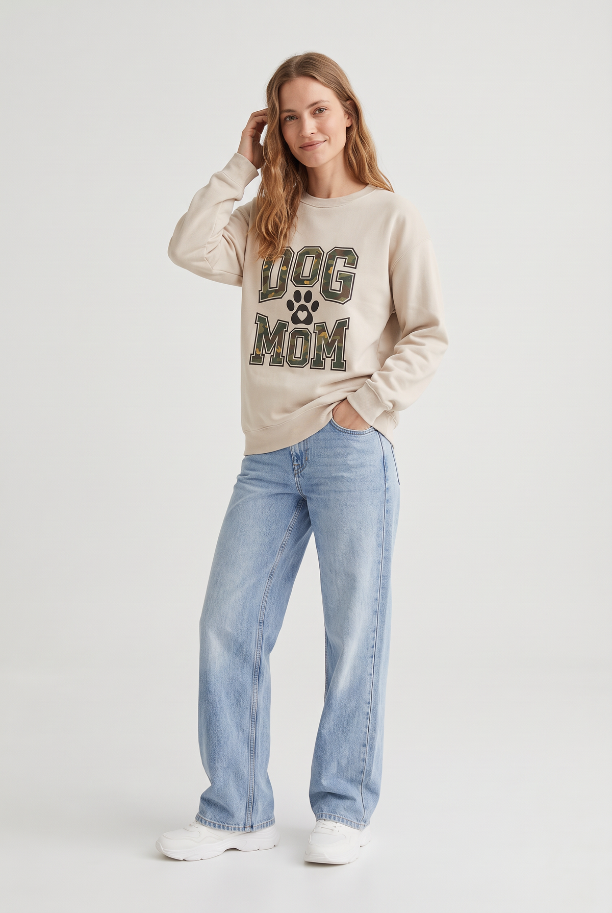 Woman wearing the Camo Dog Mom sweatshirt in sand, three-quarter view. Color: Sand