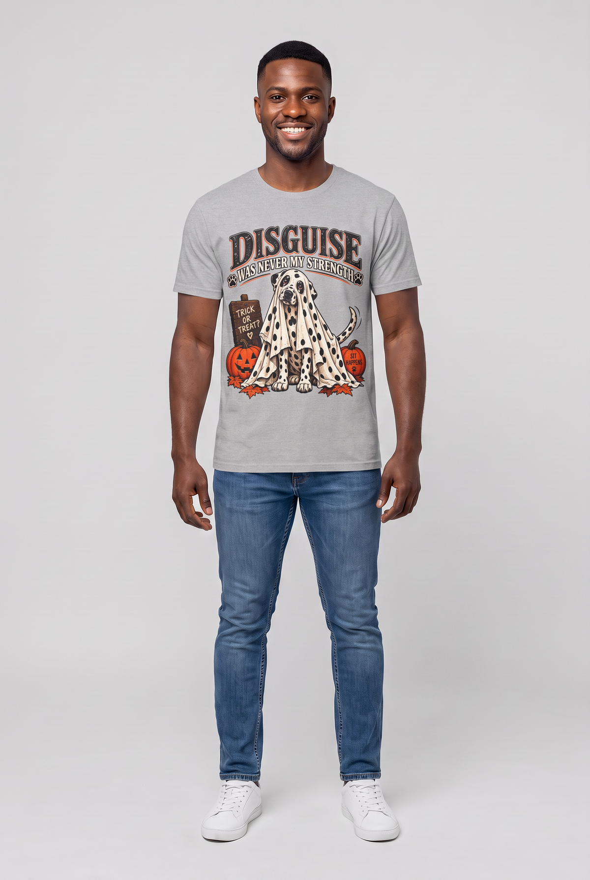 Man wearing a sport grey funny Dalmatian Halloween t-shirt with a Dalmatian under a spotted ghost sheet and the text Disguise Was Never My Strength, front view