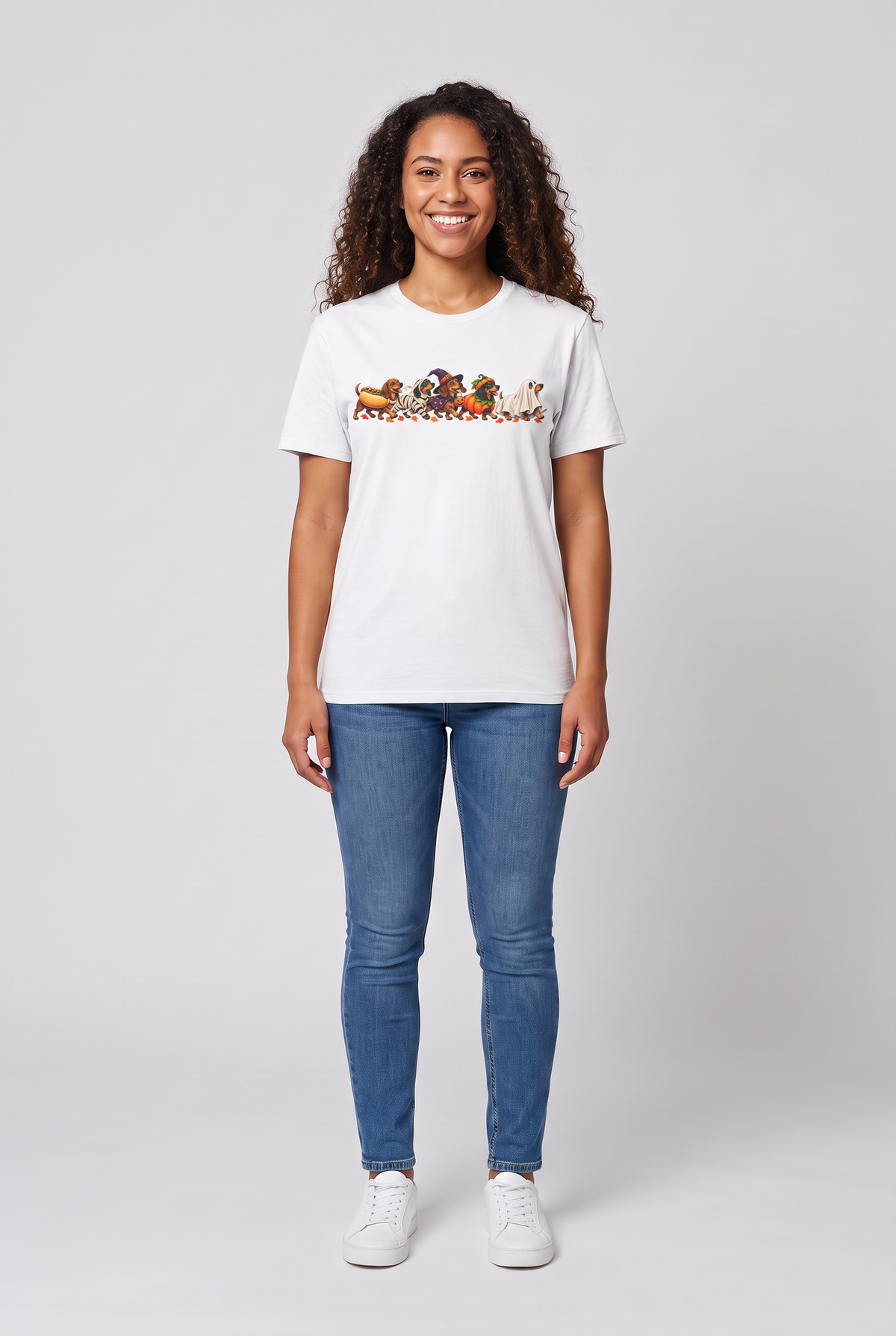 Woman wearing a white wiener dog Halloween parade t-shirt with five dachshunds dressed as hot dog, mummy, witch, pumpkin and ghost, front view