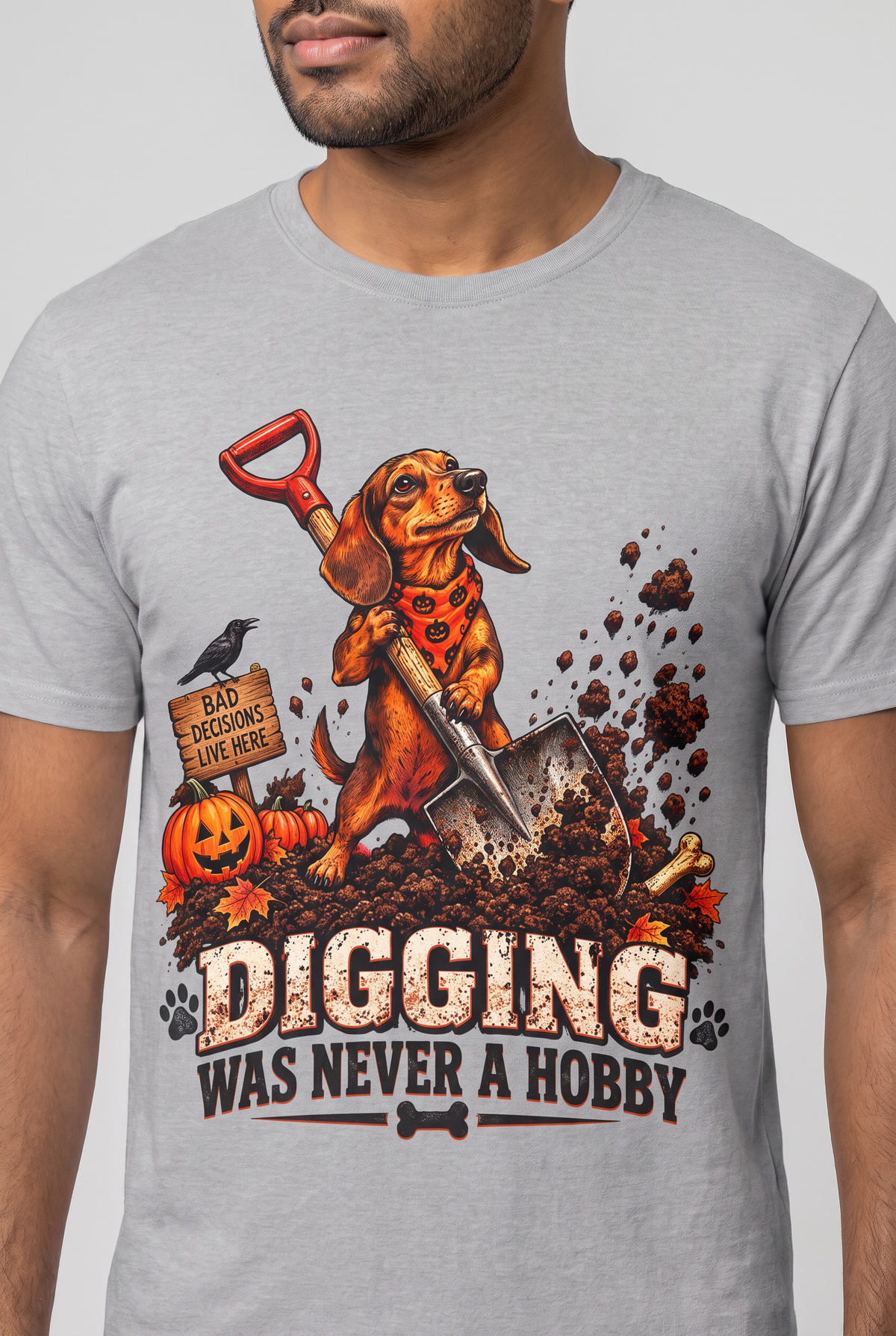 Close-up of the chest print on a sport grey funny dachshund Halloween t-shirt with a digging wiener dog and the text Digging Was Never A Hobby