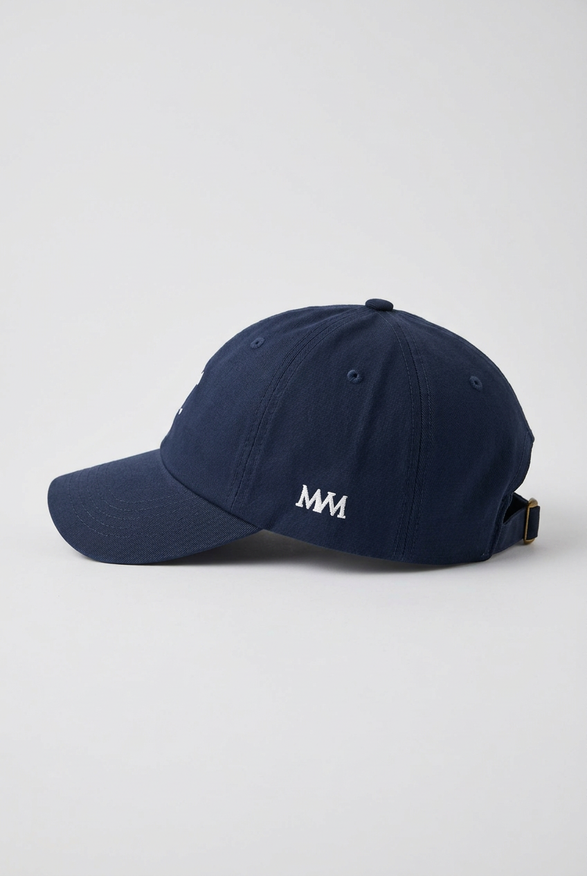 Color: Navy. Golf cap, angled side view with white Swing dachshund and MVM monogram
