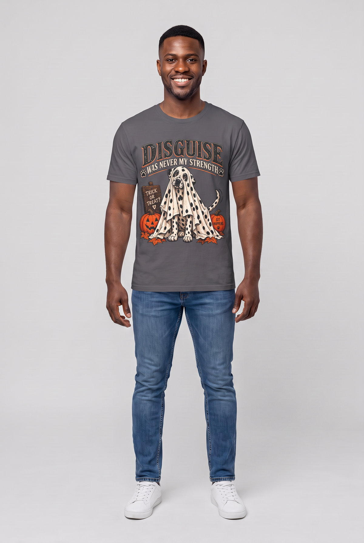 Man wearing a charcoal funny Dalmatian Halloween t-shirt with a Dalmatian under a spotted ghost sheet and the text Disguise Was Never My Strength, front view