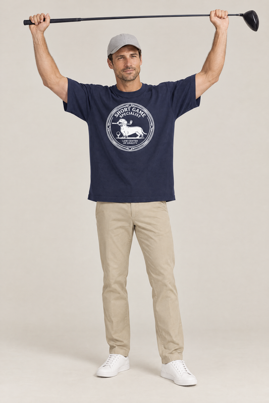 Man stretching with a driver above his head in the navy Short Game Specialist Dachshund Golf Tee. Color: Navy