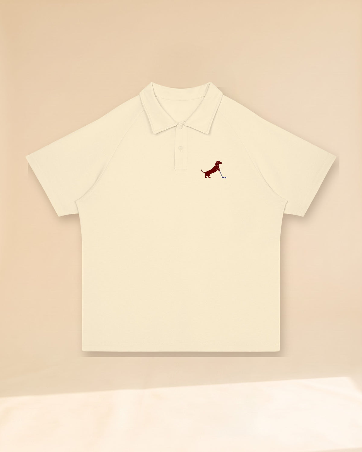 Putting dachshund golf polo, front flatlay. Color: Apricot