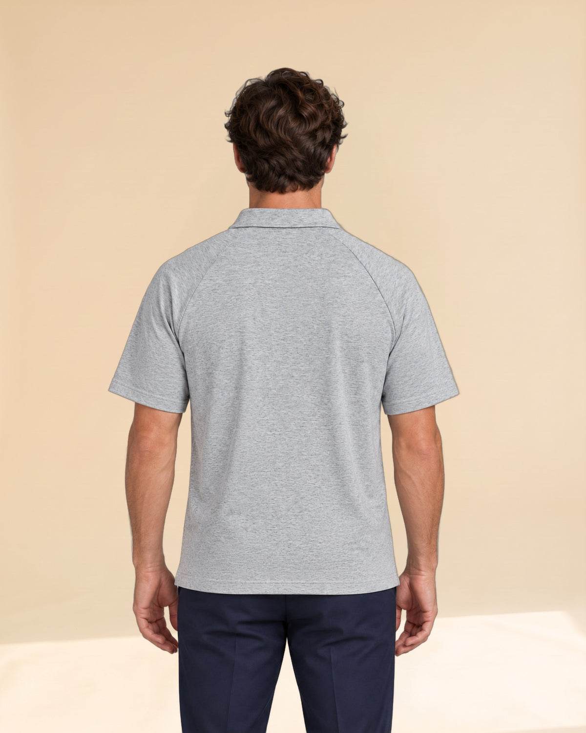 Man wearing Putting dachshund golf polo, back studio view. Color: Flower Gray