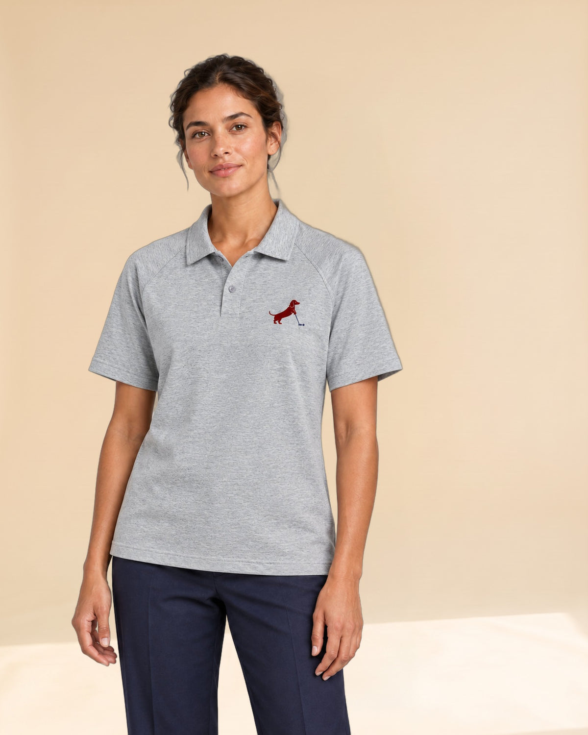Woman wearing Putting dachshund golf polo, front studio view. Color: Flower Gray