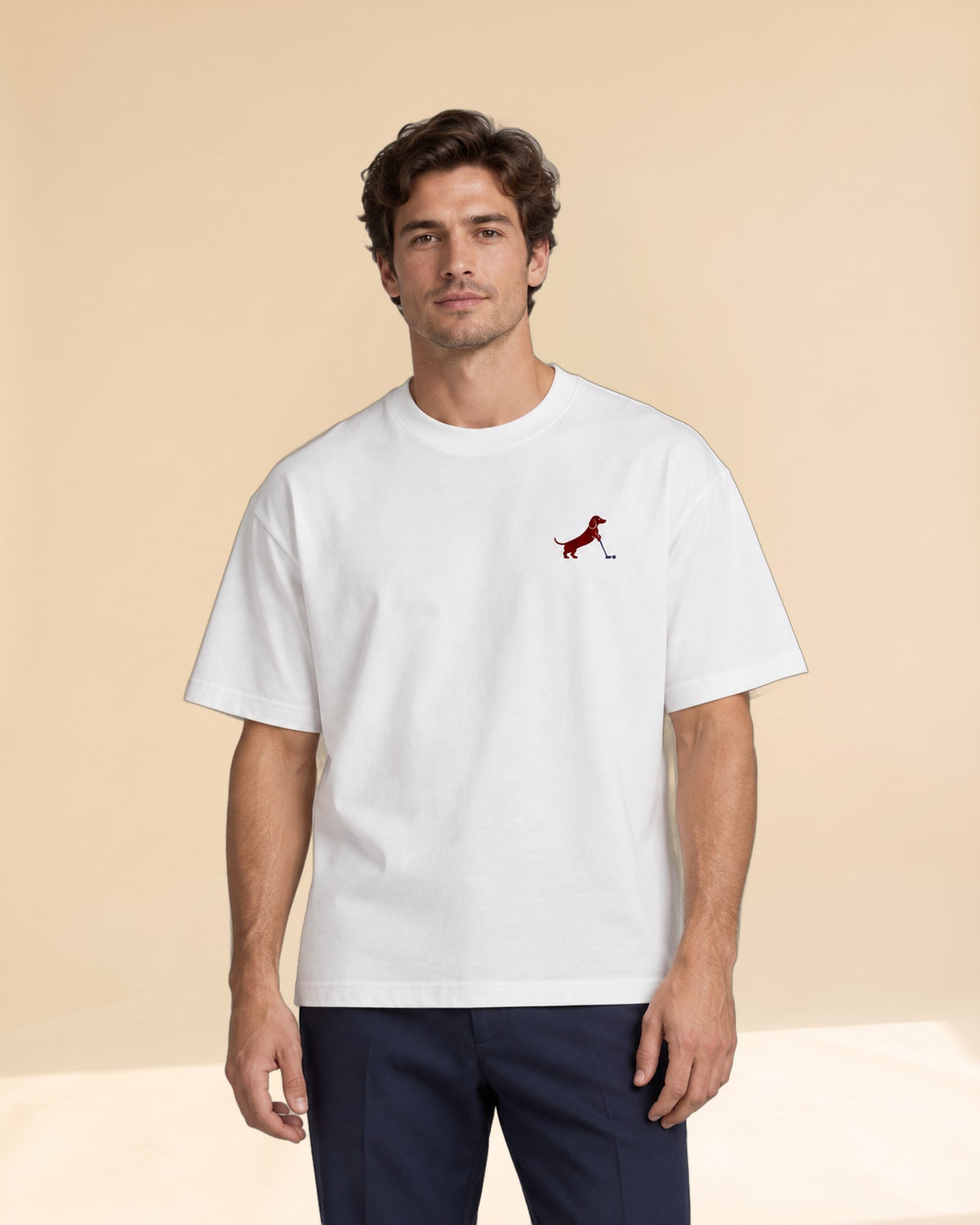 Man wearing Putting dachshund golf T-shirt, front studio view. Color: White