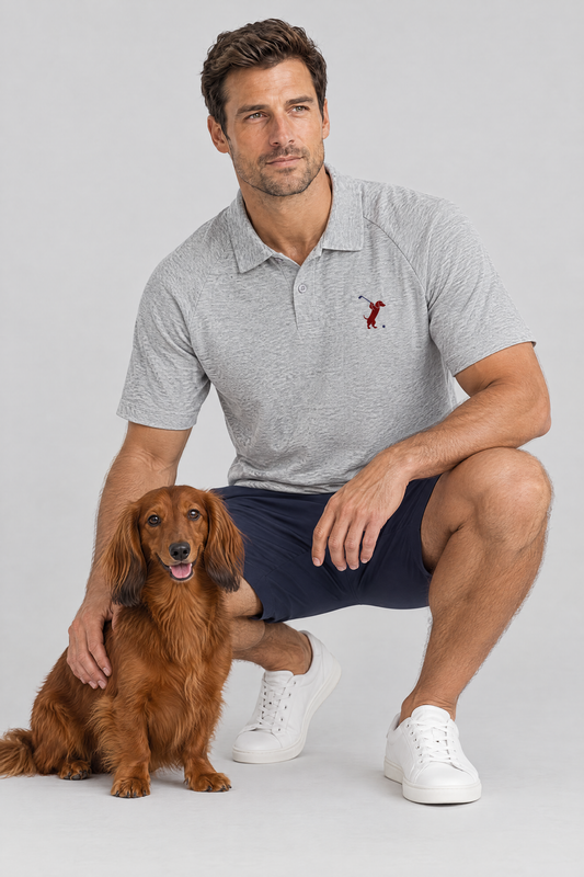 Man crouching next to a long-haired dachshund in the flower gray Swing dachshund golf polo and navy golf shorts. Color: Flower Gray