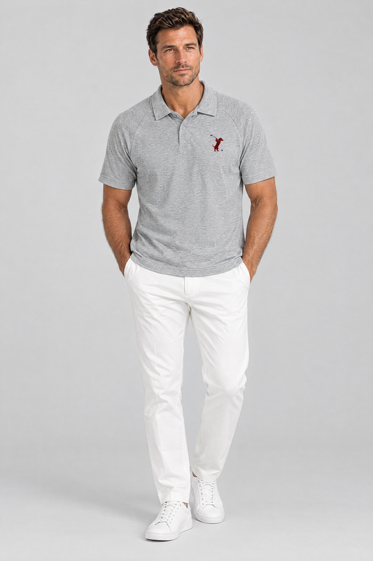 Man standing with his hands in his pockets in the flower gray Swing dachshund golf polo and white trousers. Color: Flower Gray