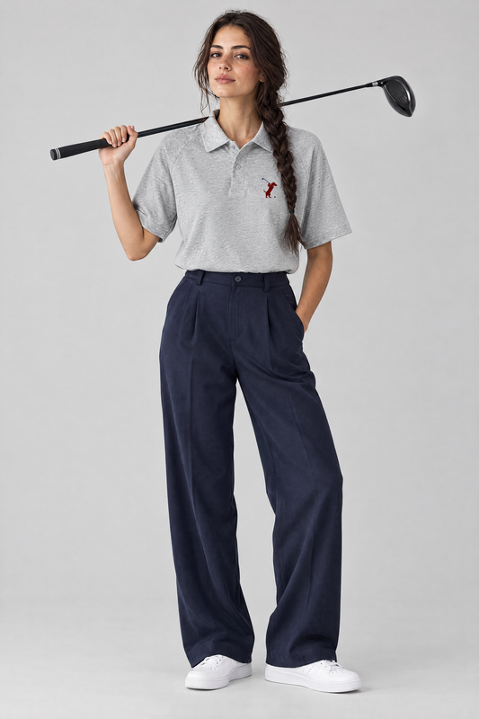 Woman holding a driver over her shoulder in the flower gray Swing dachshund golf polo and navy wide-leg trousers. Color: Flower Gray