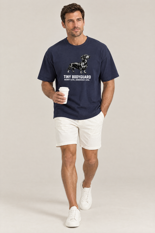 Man walking with a coffee cup in the navy Tiny Bodyguard Dachshund Tee. Color: Navy