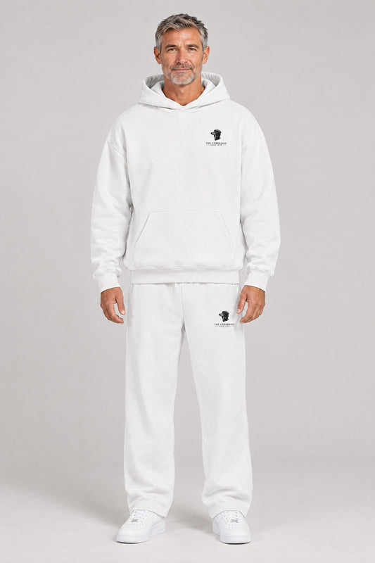 Man wearing The Long Drive dachshund golf hoodie and matching Underdog Golf Club sweatpants in White, front view. Color: White