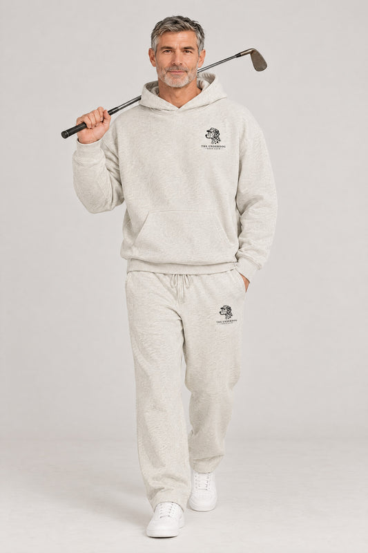 Man walking in The Sweet Spot Dalmatian golf hoodie and sweatpants set in Oat Gray. Color: Oat Gray