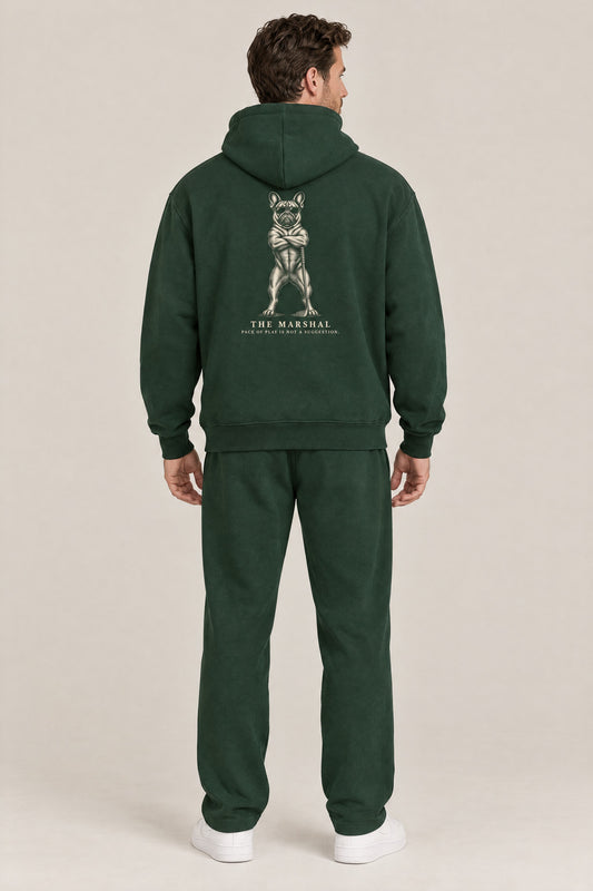 Man seen from behind in The Marshal French Bulldog golf hoodie in Blackish Green, showing the large back print. Color: Blackish Green