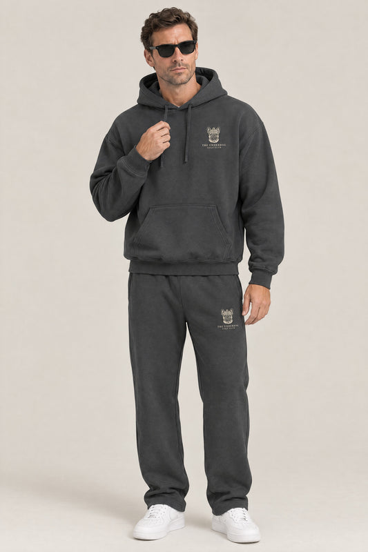 Man wearing The Marshal French Bulldog golf hoodie and matching Underdog Golf Club sweatpants in Dark Gray, front view. Color: Dark Gray