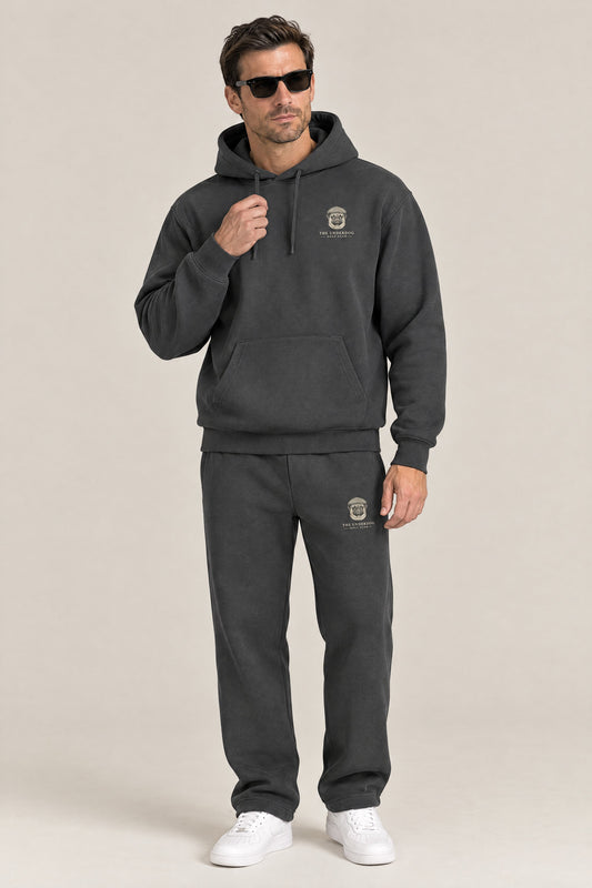 Man wearing The Heavy Hitter pug golf hoodie and matching Underdog Golf Club sweatpants in Dark Gray, front view. Color: Dark Gray