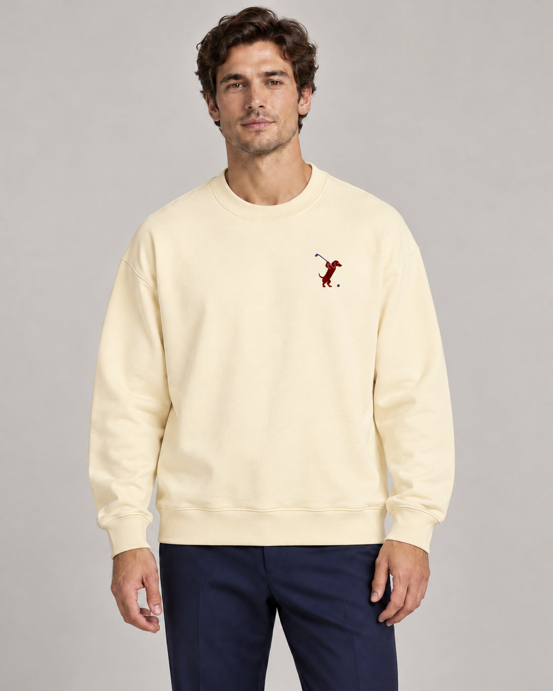 Man wearing Swing dachshund golf sweatshirt, front studio view. Color: Apricot