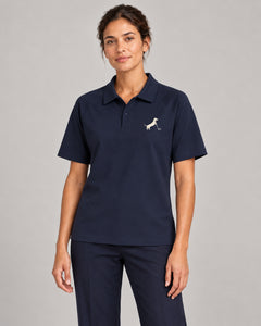 Woman wearing Putting dachshund golf polo, front studio view. Color: Navy Blue