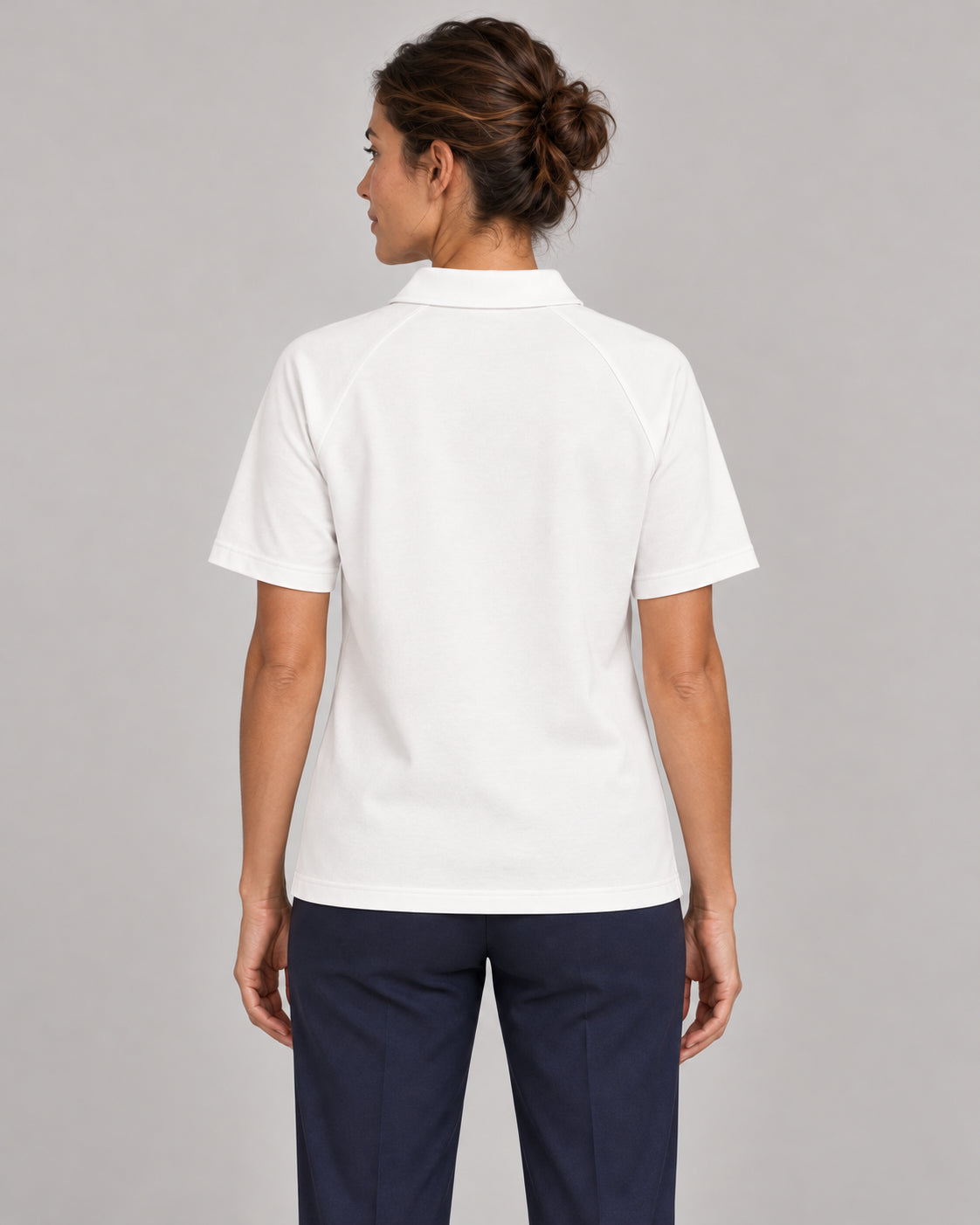 Woman wearing Putting dachshund golf polo, back studio view. Color: White