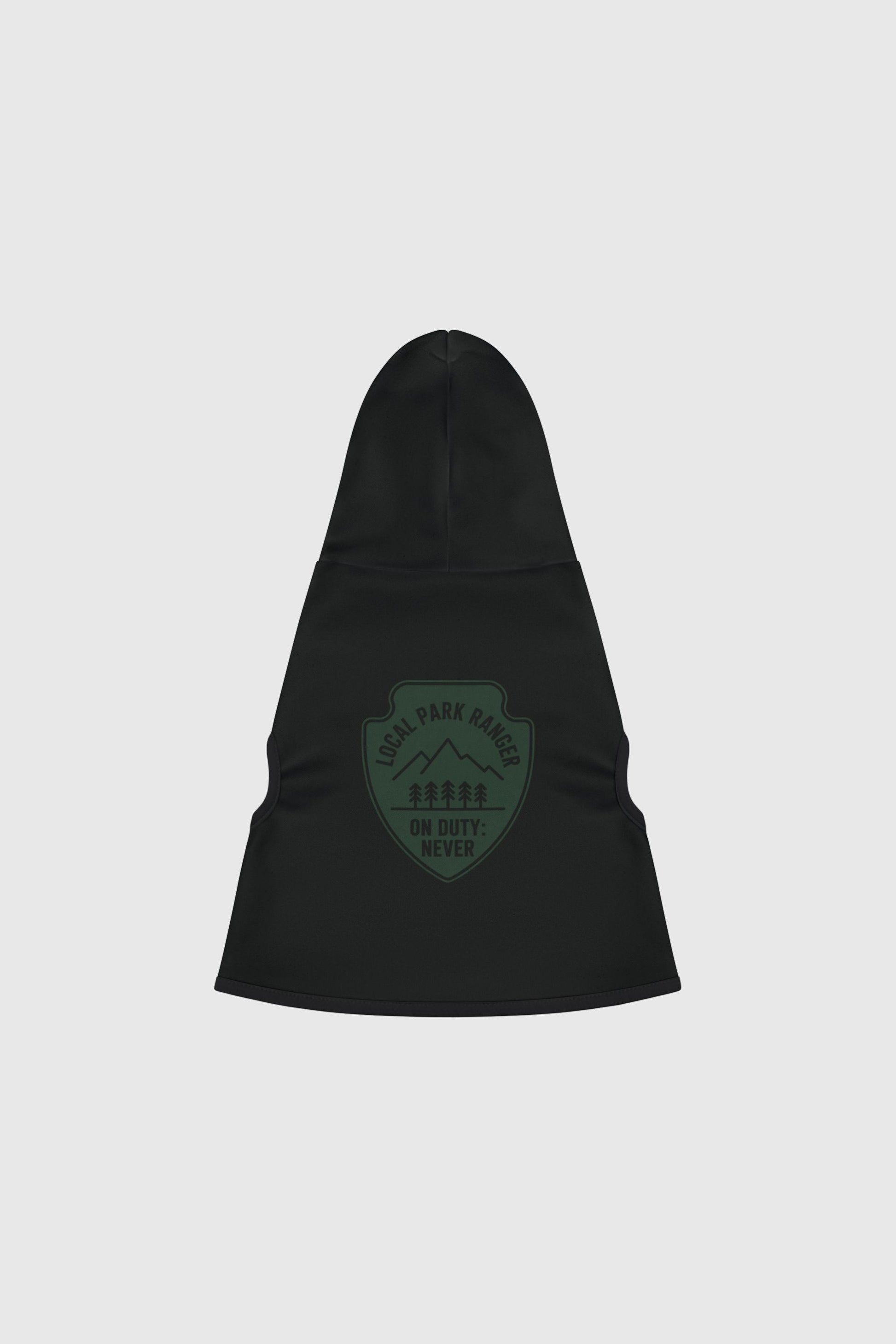 Dachshund in green local park ranger dog hoodie, outdoor setting