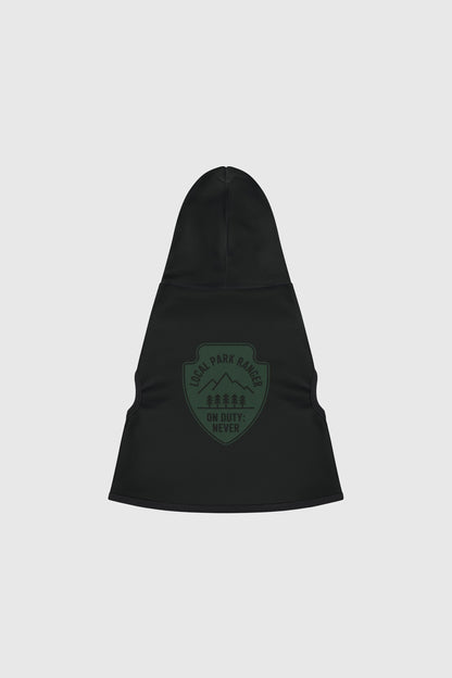 Dachshund in green local park ranger dog hoodie, outdoor setting