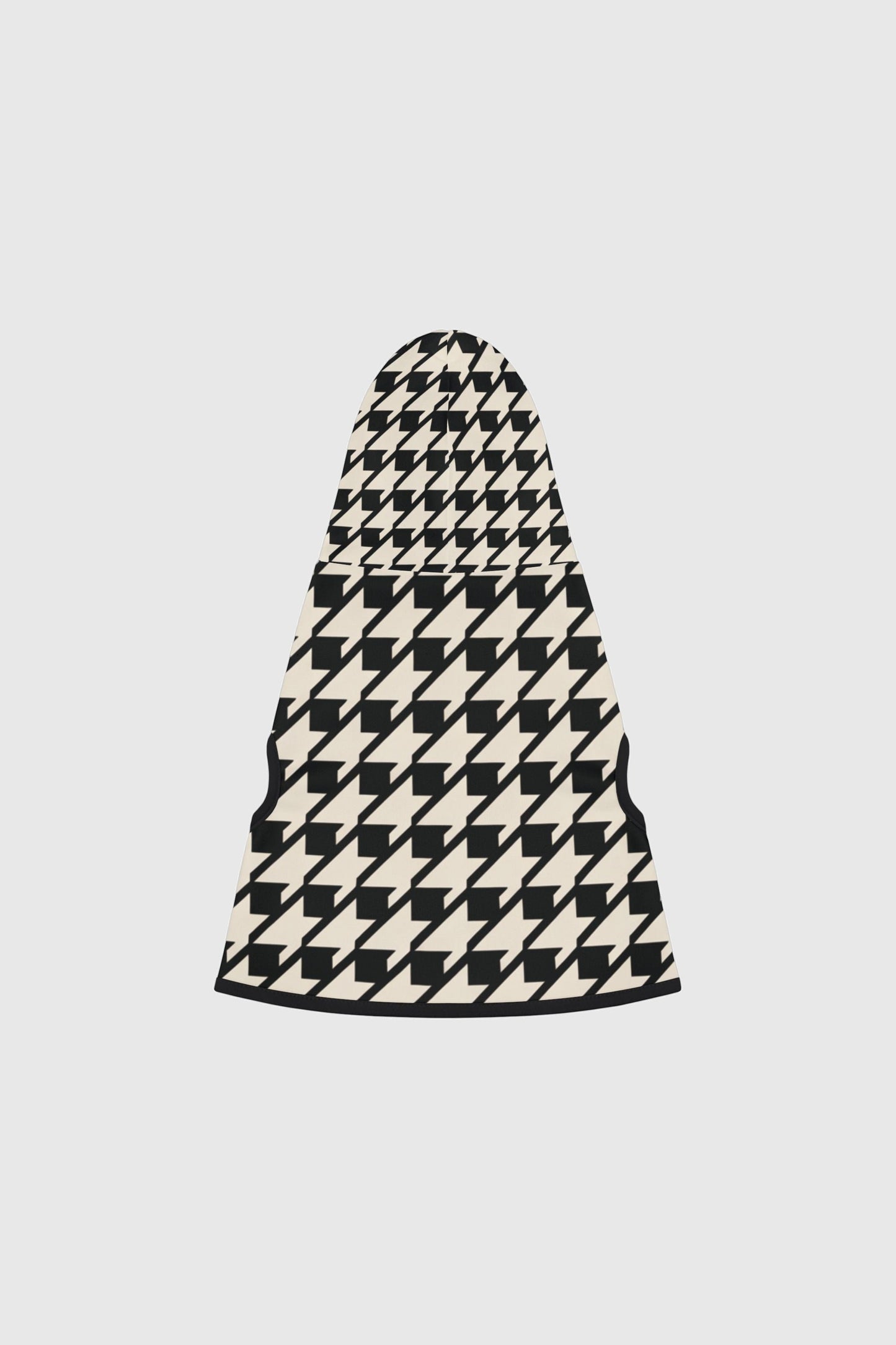 Dachshund wearing black and cream cozy dog sweater