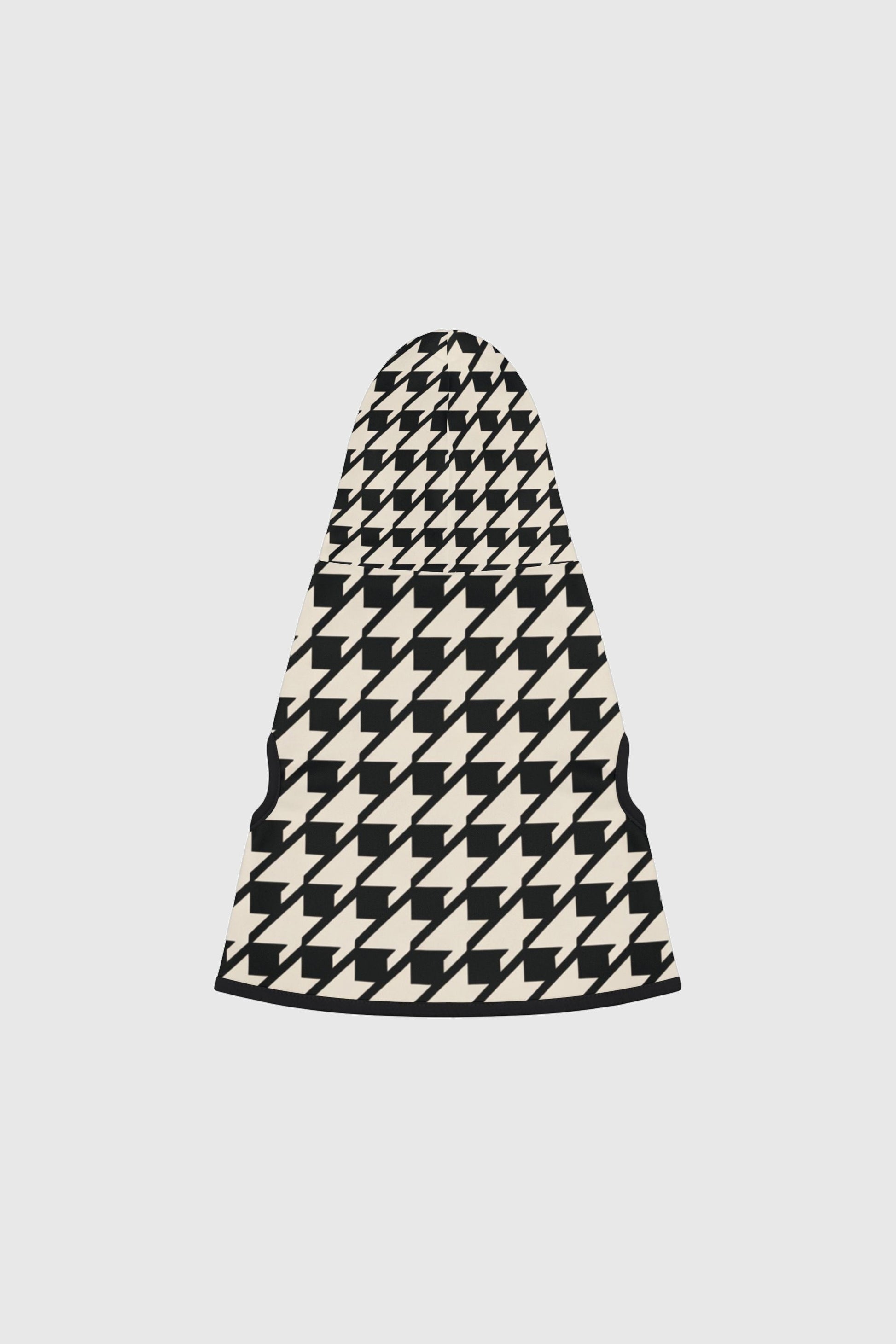 Dachshund wearing black and cream cozy dog sweater