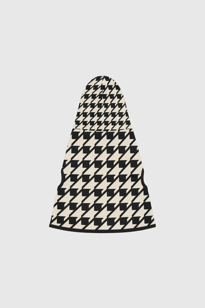 Dachshund wearing black and cream cozy dog sweater