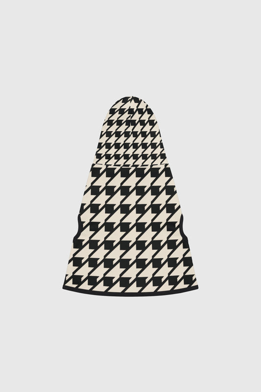 Dachshund wearing black and cream cozy dog sweater