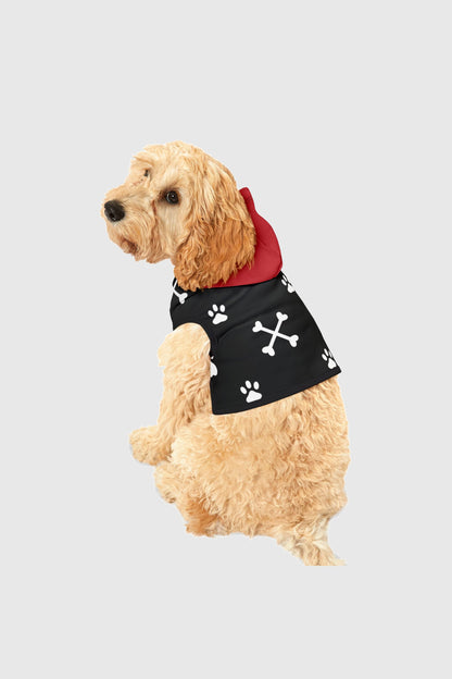 Golden retriever wearing white dog hoodie with paw print crossbones
