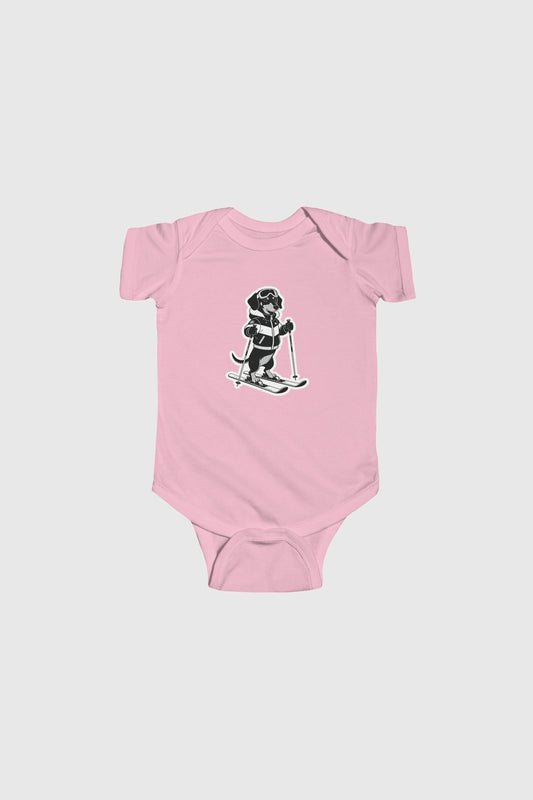 Baby wearing pink skiing black labrador bodysuit