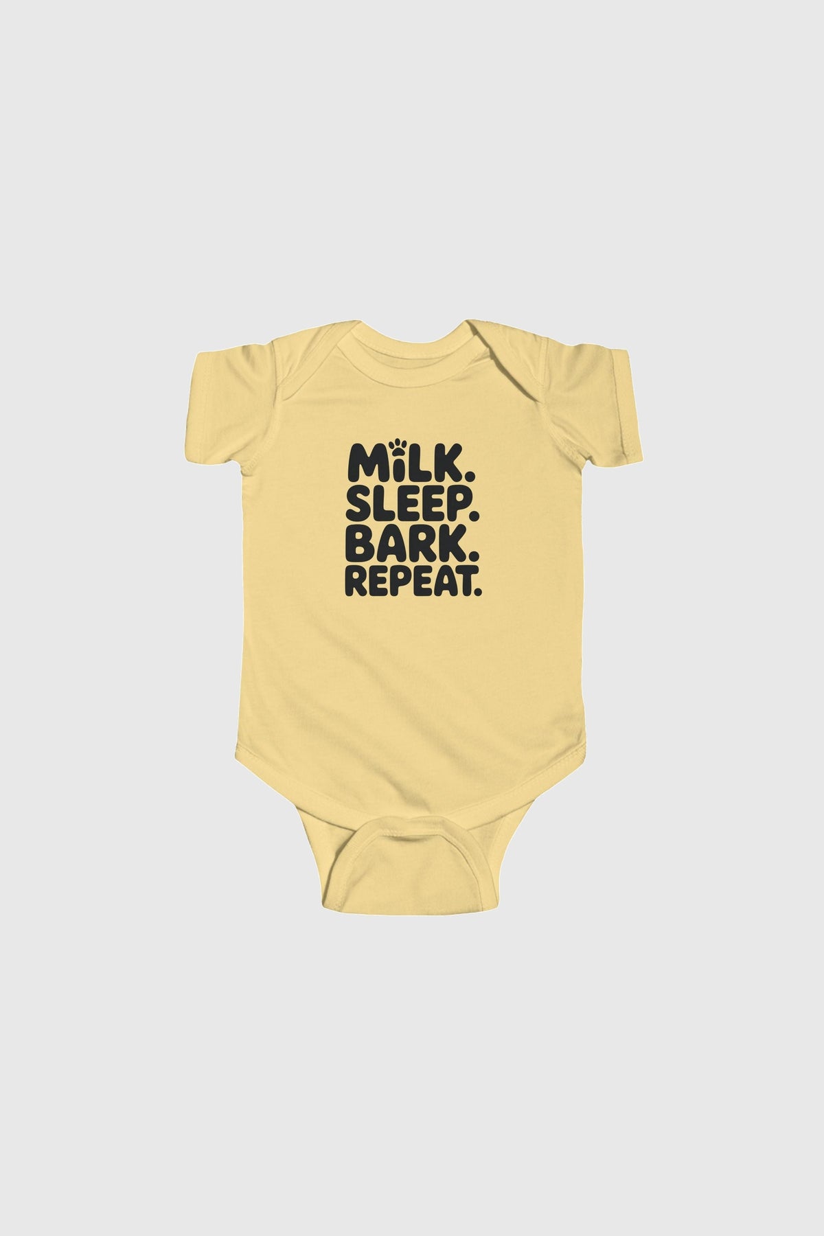 Baby wearing yellow Milk Sleep Bark Repeat bodysuit