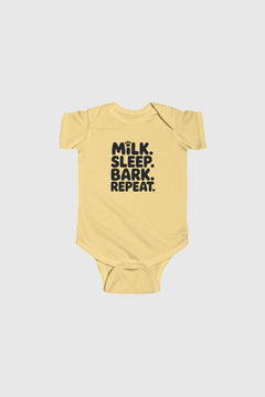 Baby wearing yellow Milk Sleep Bark Repeat bodysuit